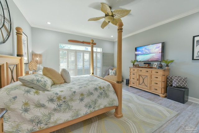 bedroom featuring ceiling fan, crown molding, and light hardwood / wood-style flooring