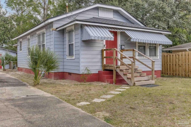 bungalow-style house with a front yard