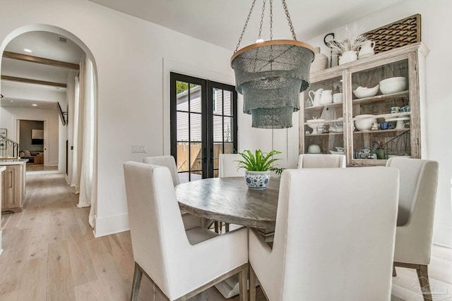 dining area featuring light wood-type flooring and french doors