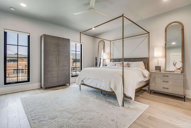 bedroom featuring ceiling fan and light hardwood / wood-style flooring