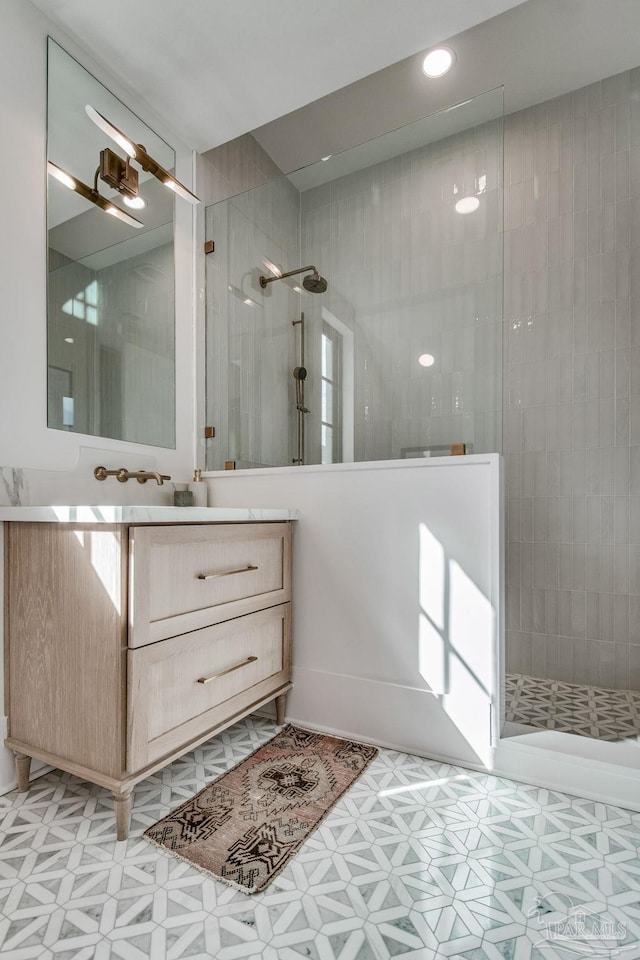 bathroom with vanity and tiled shower