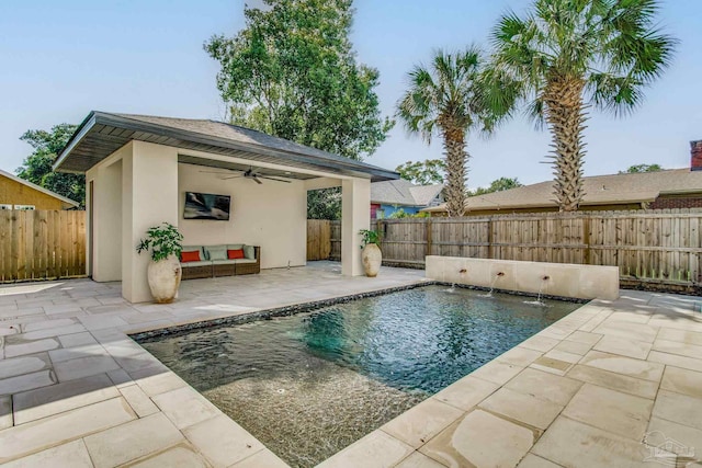 view of pool with ceiling fan, a patio, and pool water feature