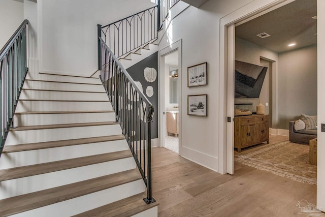 stairway featuring hardwood / wood-style flooring