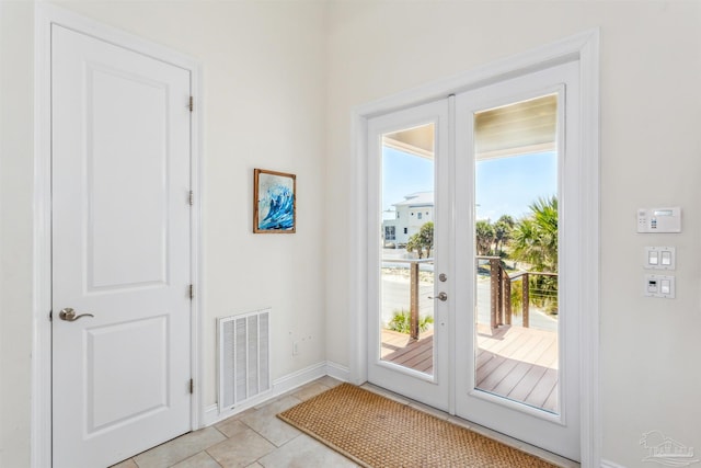 entryway featuring french doors and light tile patterned flooring