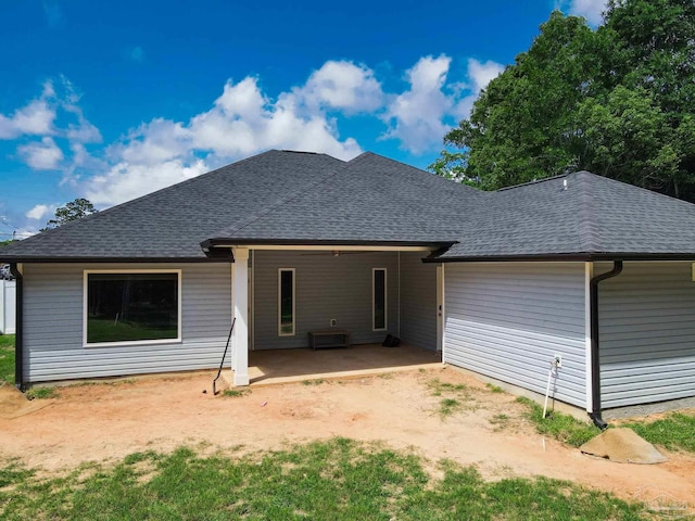 1758 Tate Rd, Cantonment, FL 32533 - rear view of house with a shingled roof, a patio, driveway, and a carport