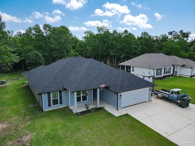 1758 Tate Rd, Cantonment, FL 32533 - view of front of house with a shingled roof, driveway, a front yard, and an attached garage