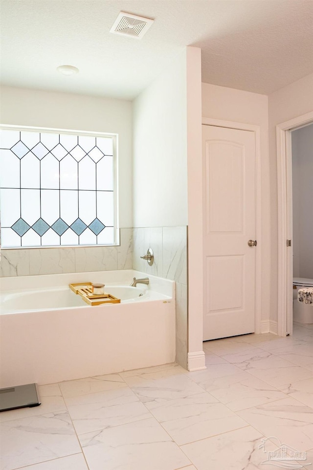 1758 Tate Rd, Cantonment, FL 32533 - bathroom featuring a bath and marble finish floors