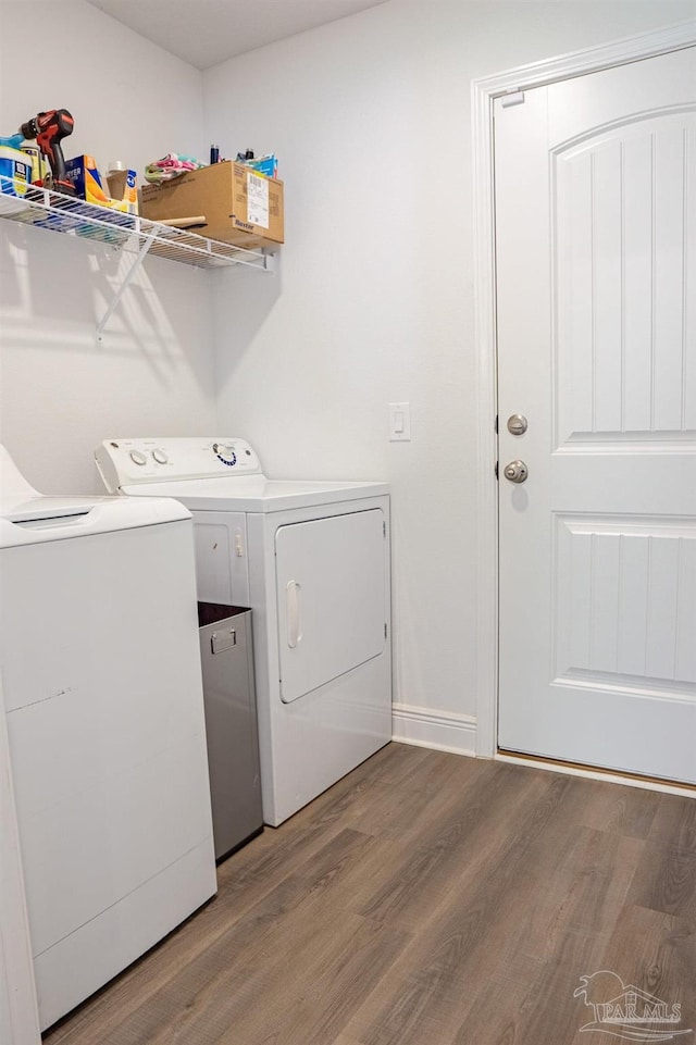 1758 Tate Rd, Cantonment, FL 32533 - laundry area with independent washer and dryer, wood finished floors, and baseboards
