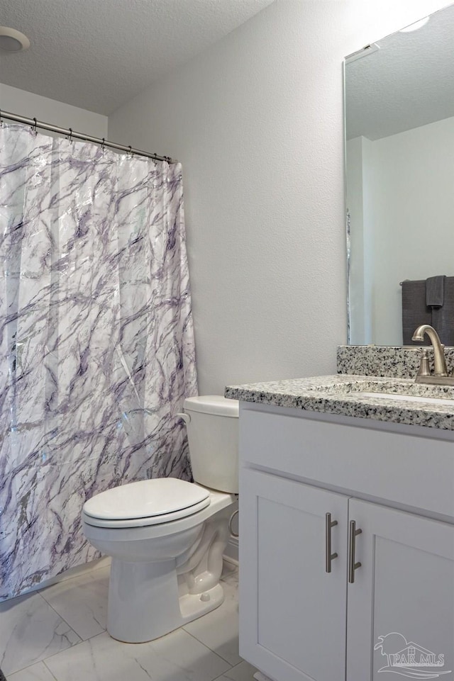 1758 Tate Rd, Cantonment, FL 32533 - full bathroom featuring toilet, marble finish flooring, vanity, a textured ceiling, and a shower with curtain