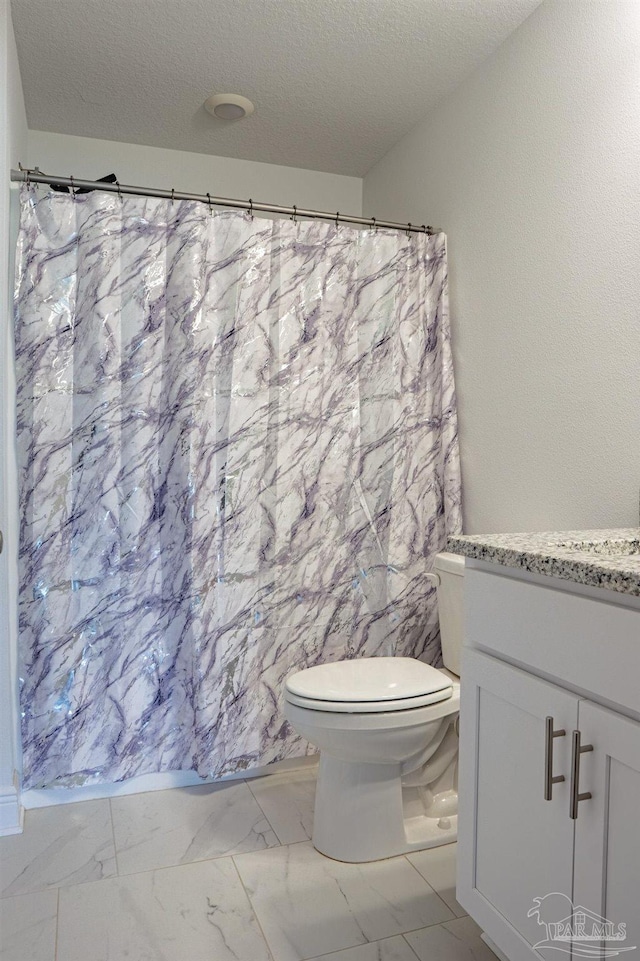 1758 Tate Rd, Cantonment, FL 32533 - bathroom with marble finish floors, toilet, vanity, a textured ceiling, and a shower with shower curtain