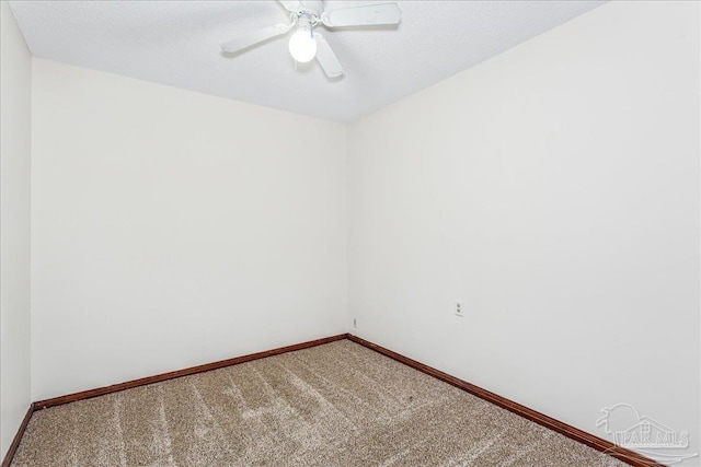 carpeted empty room featuring a textured ceiling and ceiling fan