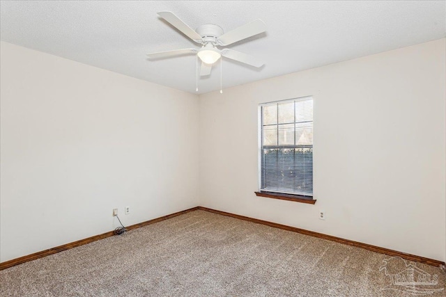 carpeted spare room with ceiling fan and a textured ceiling