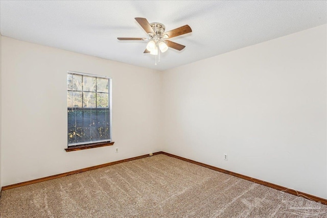 carpeted empty room featuring a textured ceiling and ceiling fan