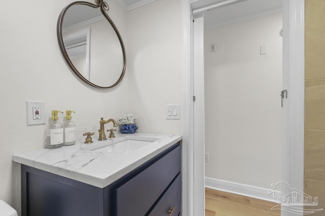 bathroom with vanity, wood-type flooring, and crown molding