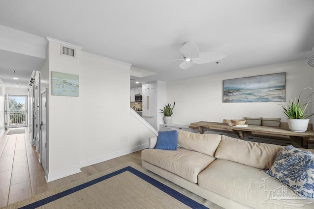 living room with ceiling fan and light hardwood / wood-style flooring