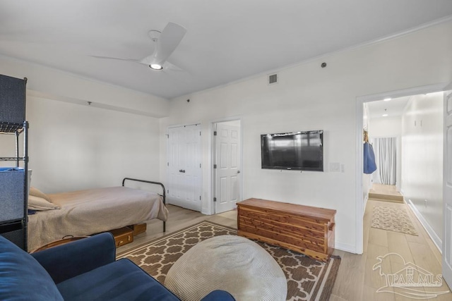 bedroom with ceiling fan and light wood-type flooring