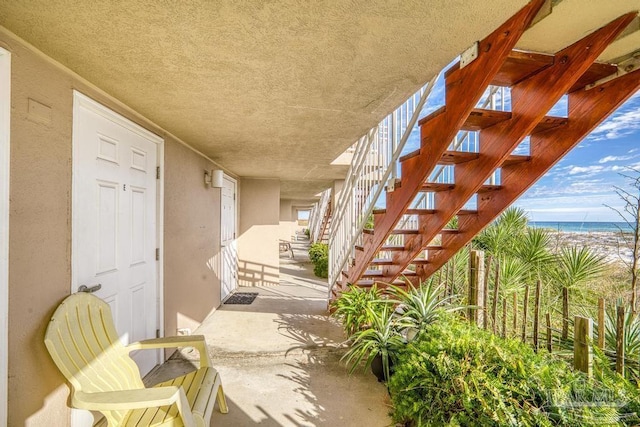 exterior space featuring a water view and a patio