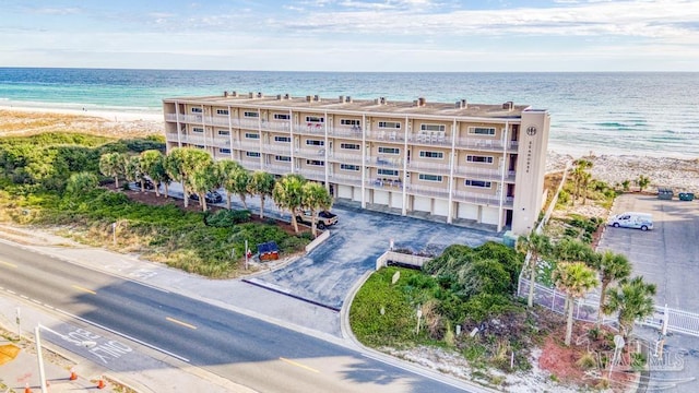 view of building exterior featuring a water view and a view of the beach