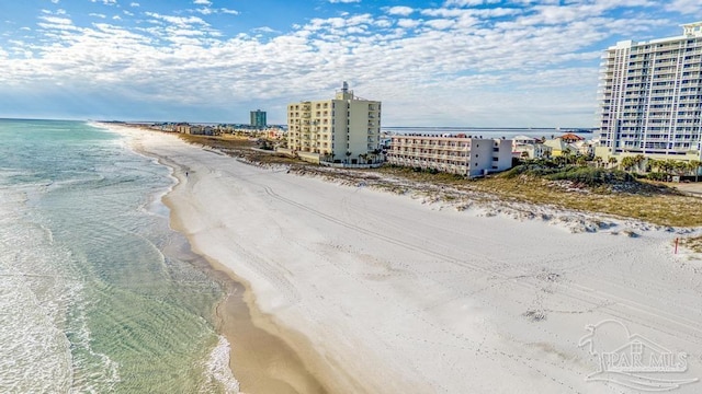 bird's eye view featuring a water view and a beach view