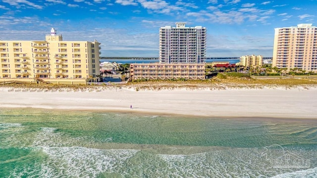 birds eye view of property featuring a water view and a beach view