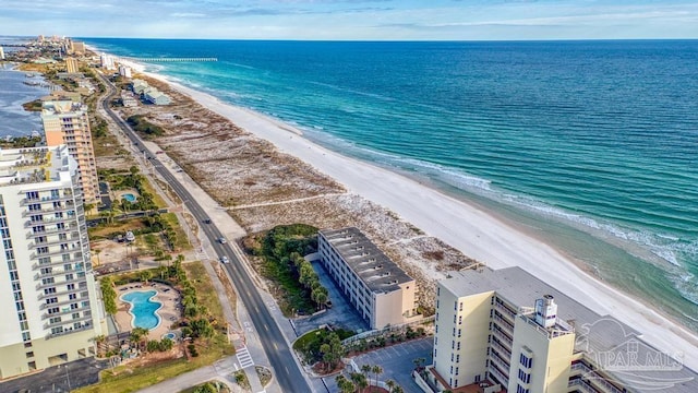 bird's eye view with a water view and a beach view