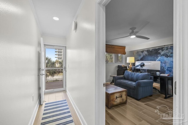 hallway with crown molding and hardwood / wood-style flooring