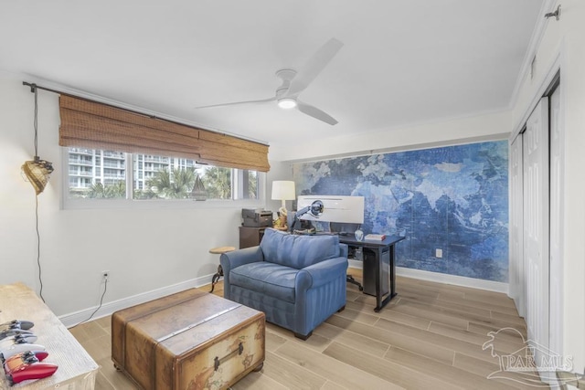 living room with ceiling fan, ornamental molding, and light hardwood / wood-style floors