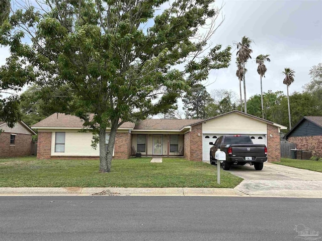 2654 Tinosa Cir, Pensacola, FL 32526 - single story home featuring concrete driveway, brick siding, a front yard, and an attached garage