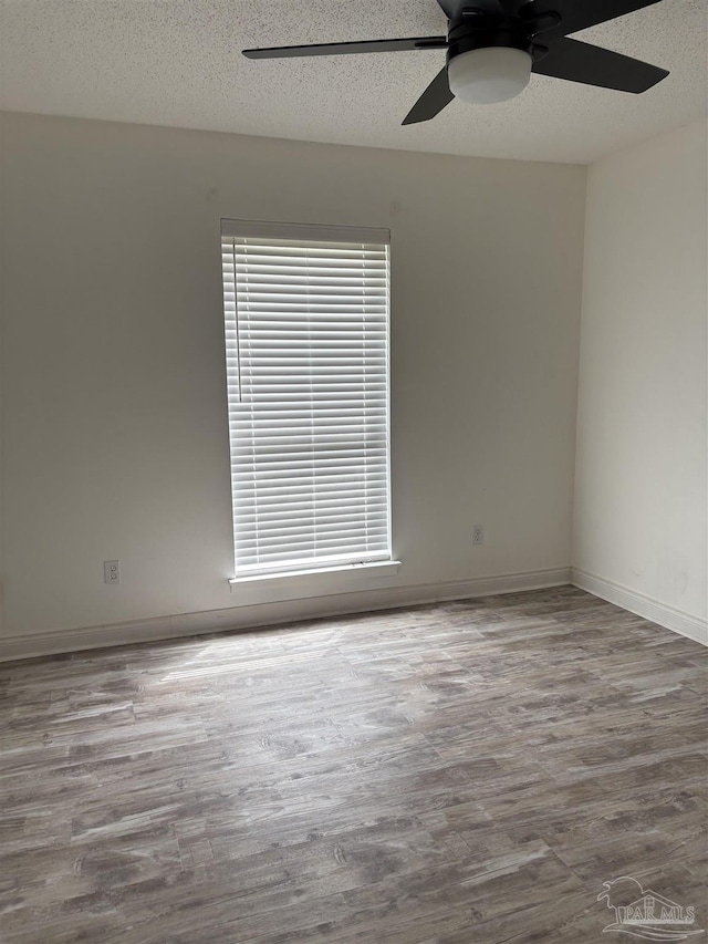 2654 Tinosa Cir, Pensacola, FL 32526 - spare room with wood finished floors, ceiling fan, and a textured ceiling
