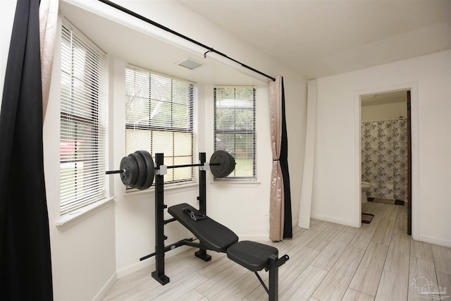 workout room with light hardwood / wood-style floors