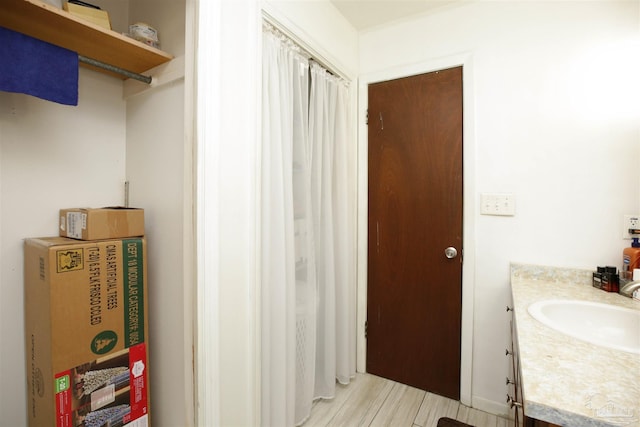 bathroom with vanity and hardwood / wood-style flooring