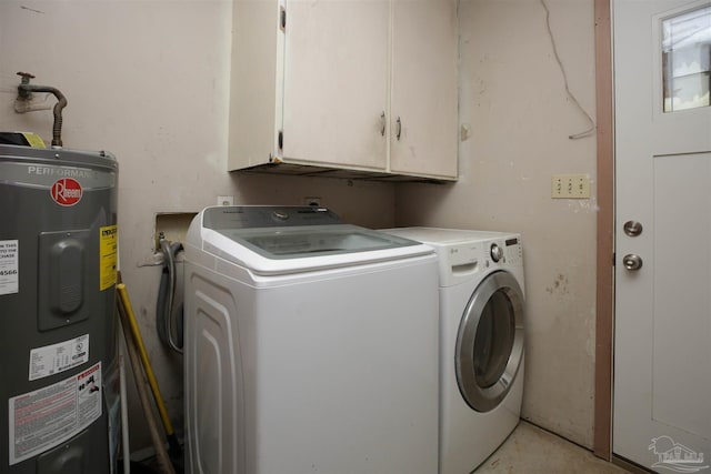 washroom featuring cabinets, independent washer and dryer, and water heater