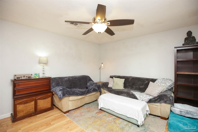 living room with ceiling fan and light wood-type flooring