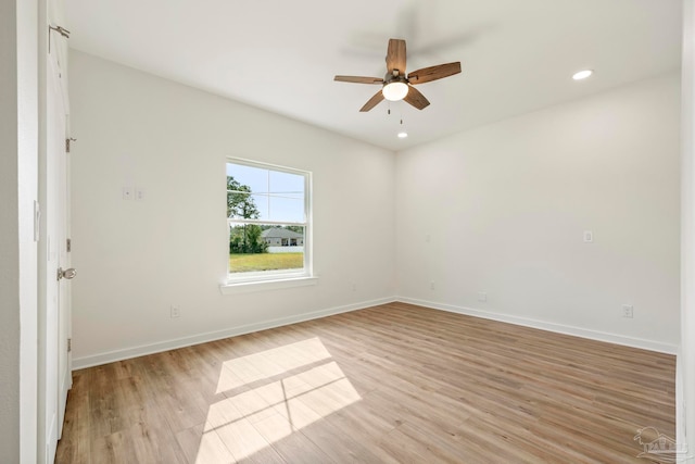 spare room featuring light wood-style flooring and baseboards