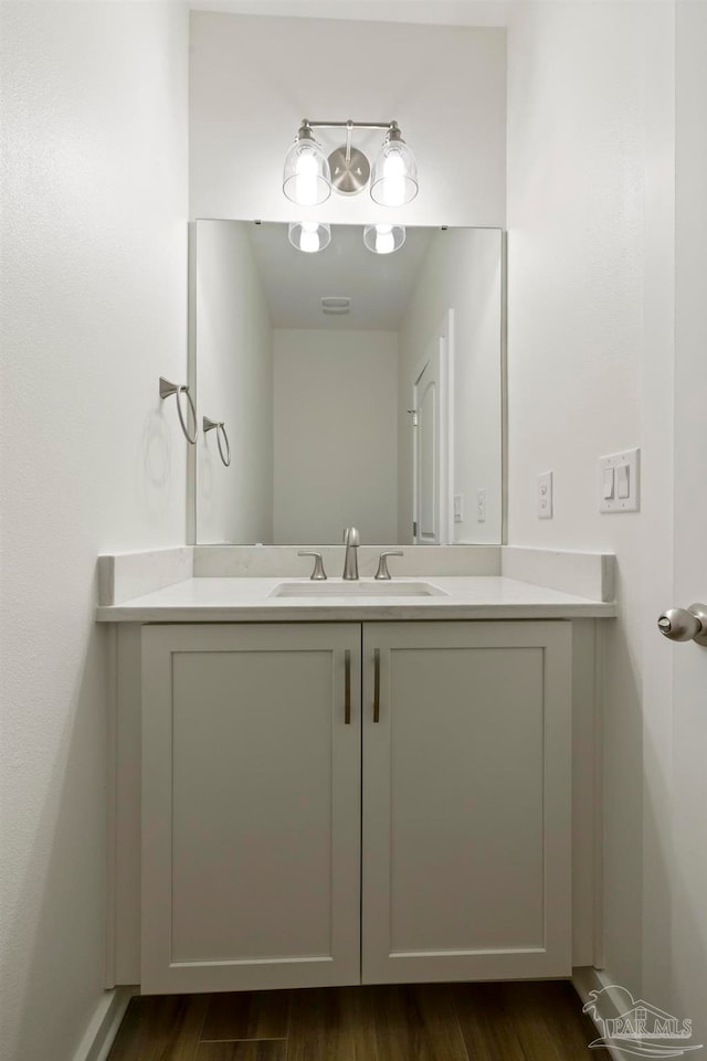 bathroom with vanity and wood finished floors