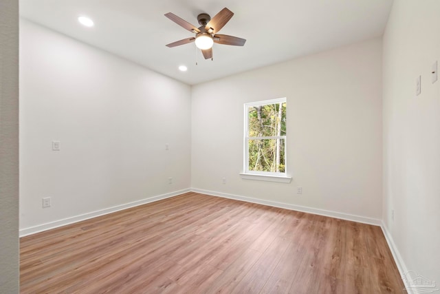 empty room with ceiling fan, recessed lighting, light wood-style flooring, and baseboards