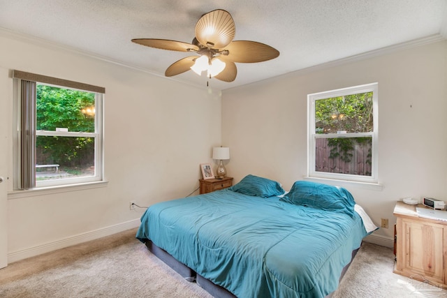 4551 Creighton Rd, Pensacola, FL 32504 - carpeted bedroom with ceiling fan, crown molding, baseboards, and multiple windows