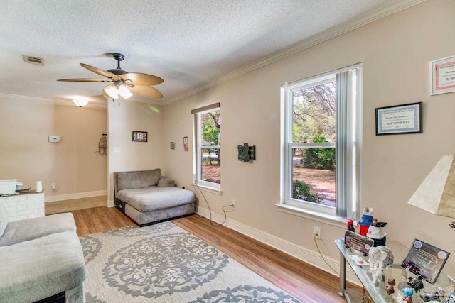 4551 Creighton Rd, Pensacola, FL 32504 - living area with visible vents, ornamental molding, a textured ceiling, and wood finished floors