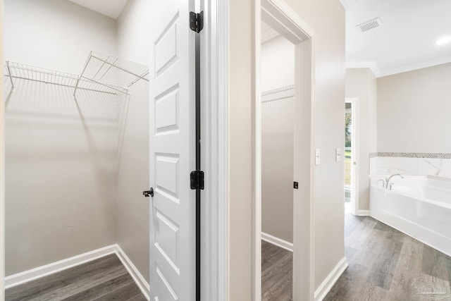 spacious closet featuring hardwood / wood-style floors