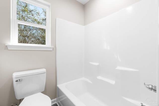 bathroom featuring bathing tub / shower combination and toilet