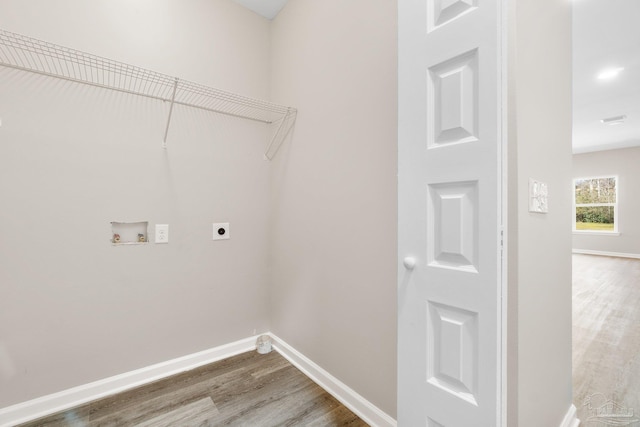 laundry room featuring hardwood / wood-style flooring, hookup for a washing machine, and electric dryer hookup