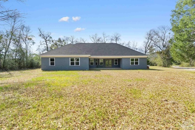 rear view of property featuring a yard