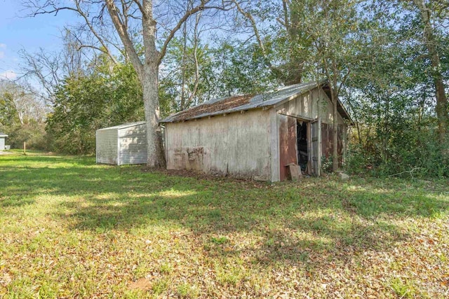 view of outbuilding featuring a lawn