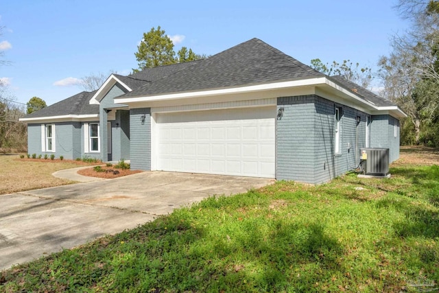 ranch-style house with a garage and central AC unit