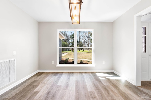 unfurnished dining area featuring light hardwood / wood-style flooring