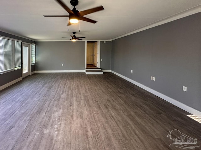 unfurnished living room featuring ceiling fan, crown molding, and dark wood-type flooring