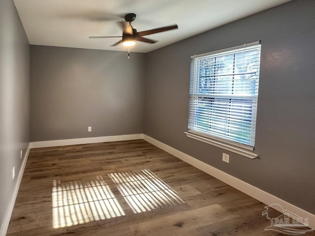 spare room with ceiling fan and dark wood-type flooring