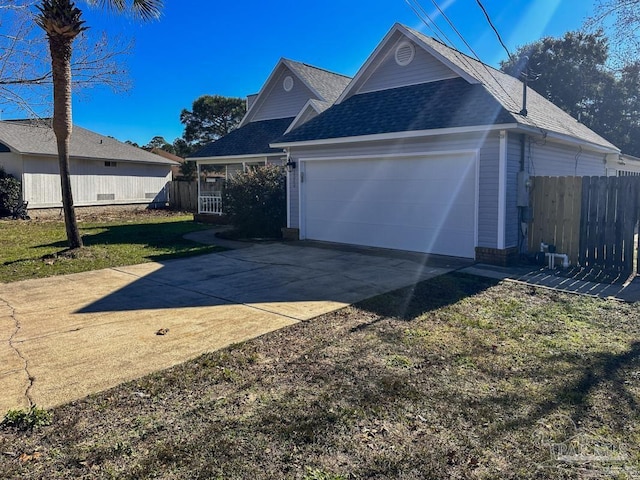 view of front of property featuring a front yard and a garage