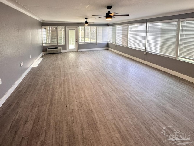 empty room featuring hardwood / wood-style flooring and ceiling fan