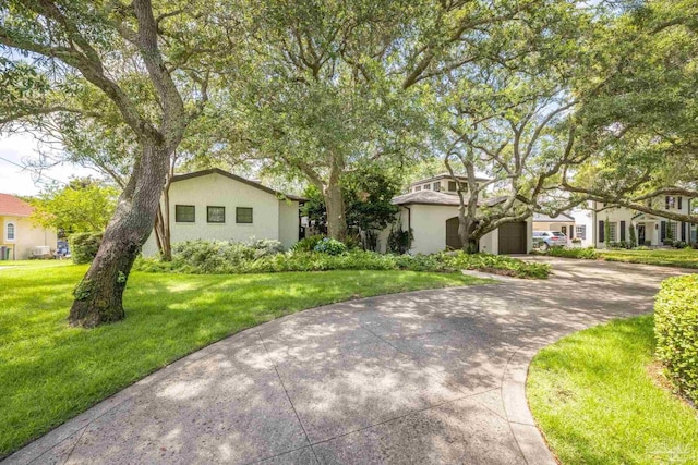 9 N Sunset Blvd, Gulf Breeze, FL 32561 - view of front facade with concrete driveway, a front yard, and stucco siding